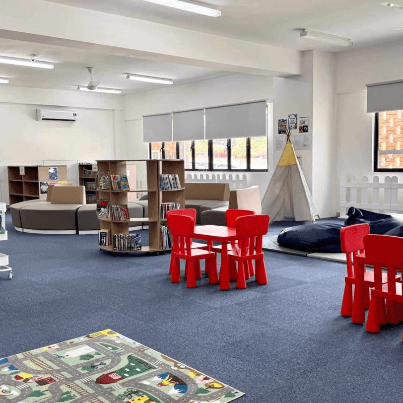 Concord College primary library with reading areas and children's books.